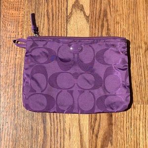 Small purple Coach toiletries bag